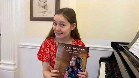 Alma holding Alma’s Piano Songs